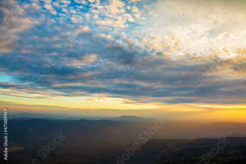 Glowing sunrise shines over mountain range. © banjongseal324