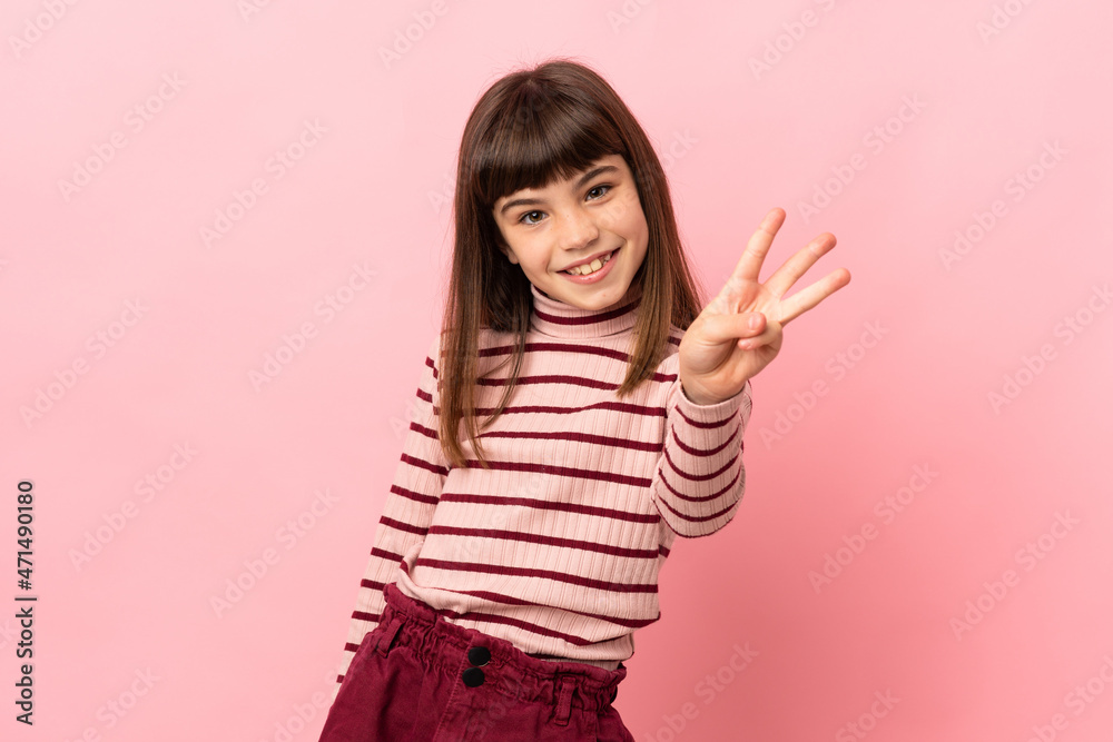 Little girl isolated on pink background happy and counting three with fingers Little girl isolated on pink background happy and counting three with fingers
