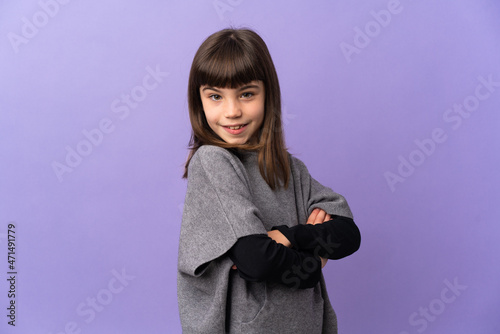 Little girl over isolated background looking to the side and smiling