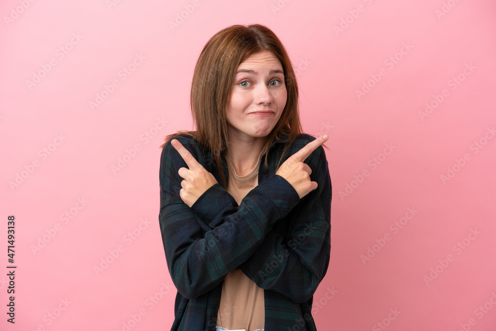 Young English woman isolated on pink background pointing to the laterals having doubts Young English woman isolated on pink background pointing to the laterals having doubts