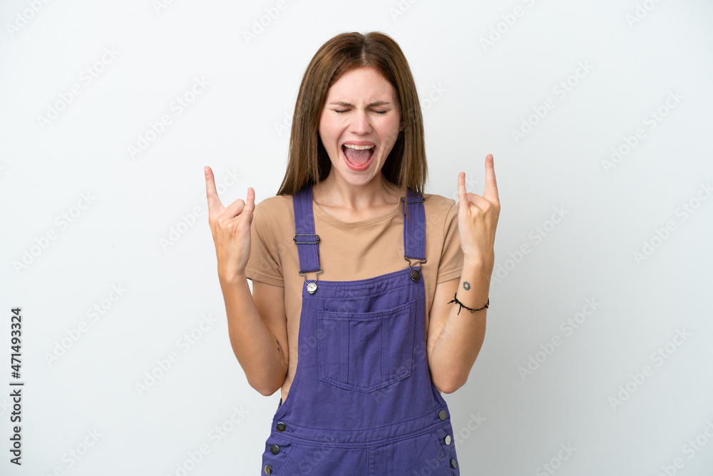 Young English woman isolated on white background making horn gesture Young English woman isolated on white background making horn gesture