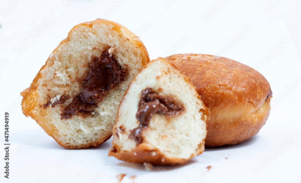 small round donuts with chocolate filling on white background