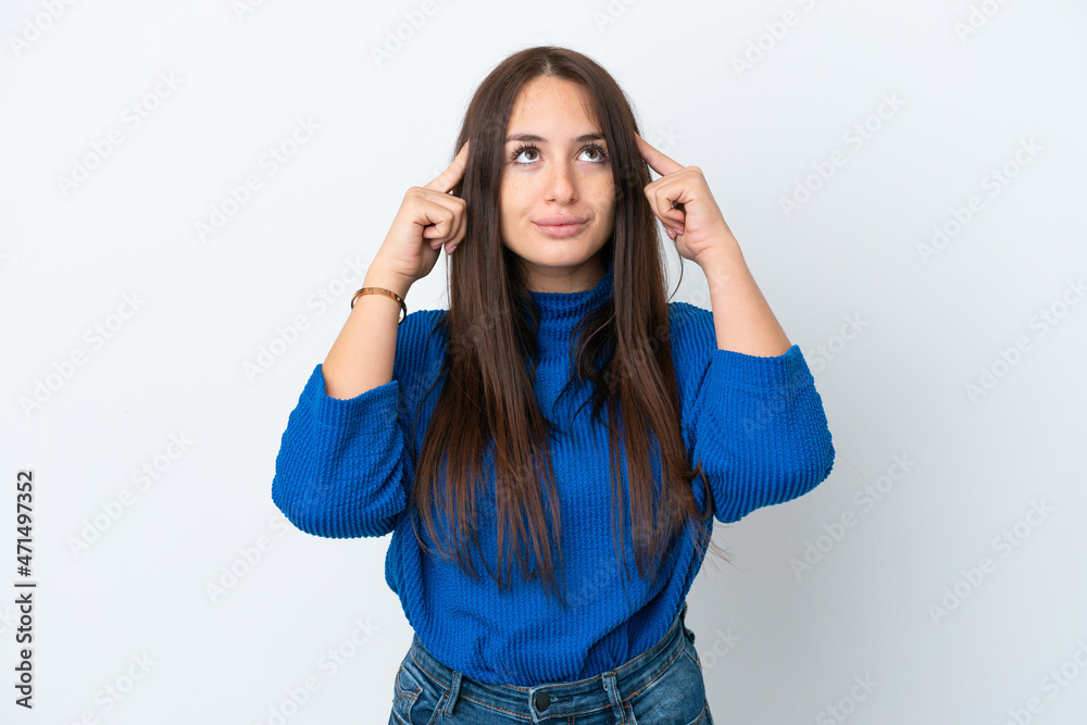 Young Ukrainian woman isolated on white background having doubts and thinking