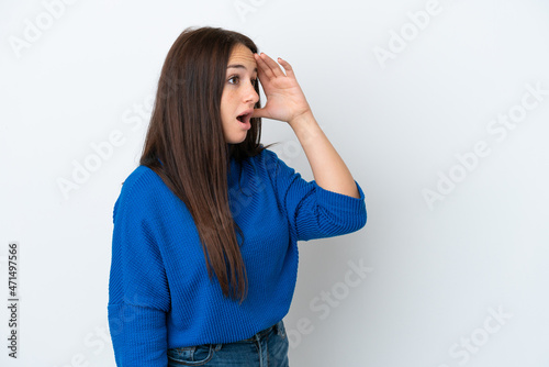 Young Ukrainian woman isolated on white background with surprise expression while looking side © luismolinero