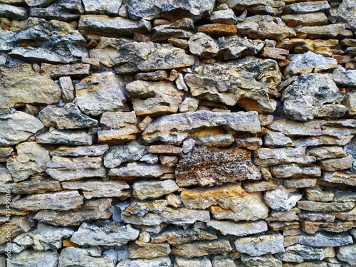 Fence made of stones of various shapes, sizes and colors
