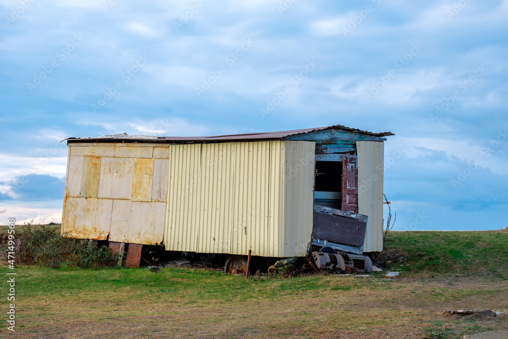 old abandoned carriage on a meadow against the backdrop of a cloudy sky with thick clouds old abandoned carriage on a meadow against the backdrop of a cloudy sky with thick clouds