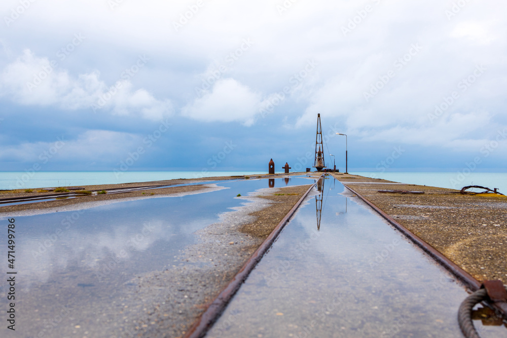 the sky is reflected in the water, puddles on the pier. sea horizon sky and sea