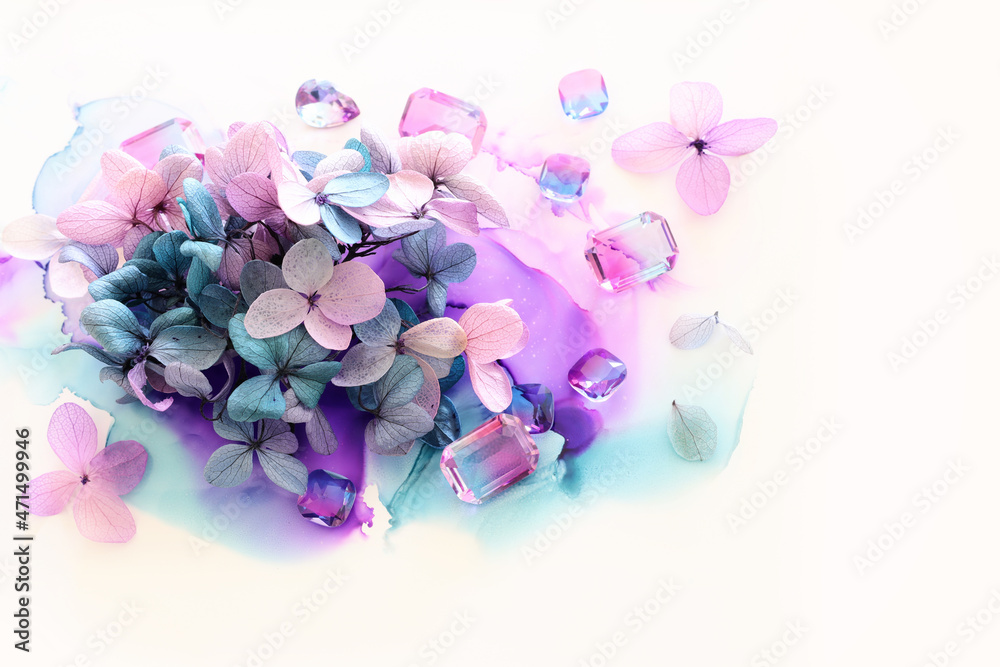 Fototapeta premium Creative image of pink and purple Hydrangea flowers on artistic ink background. Top view with copy space