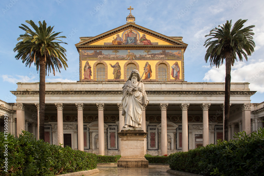 Exterior of the papal basilica of Saint Paul Outside the Walls in Rome, Italy. The facade above the colonnade is decorated with mosaics made in the 19th century.