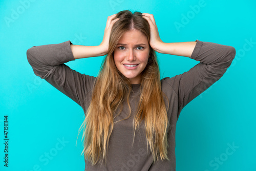 Young blonde woman isolated on blue background doing nervous gesture