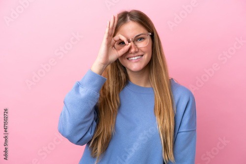 Young blonde woman isolated on pink background With glasses with happy expression
