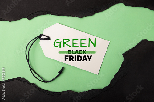 Canvas Print Torned paper on the green background,concept of green friday and black friday