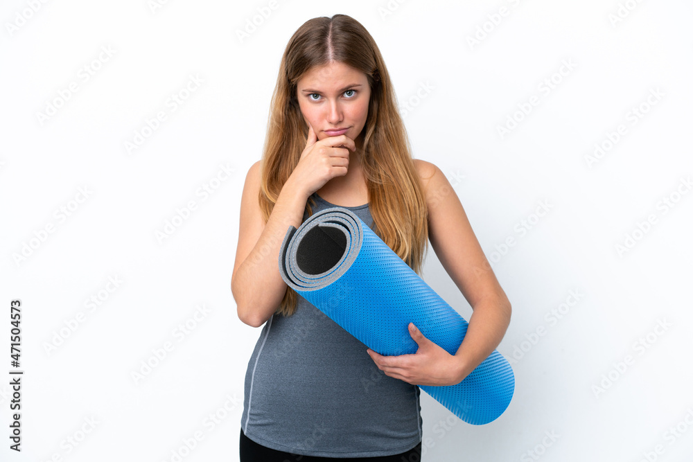 Young sport woman going to yoga classes while holding a mat thinking Young sport woman going to yoga classes while holding a mat thinking