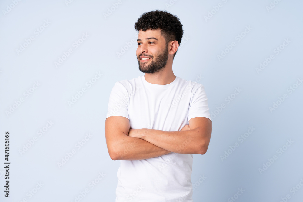 Young Moroccan man isolated on blue background happy and smiling Young Moroccan man isolated on blue background happy and smiling