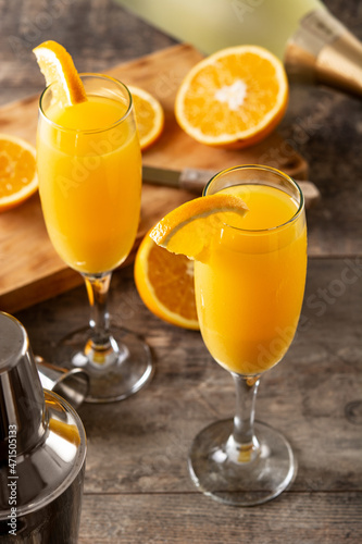 Orange mimosa cocktail on wooden table