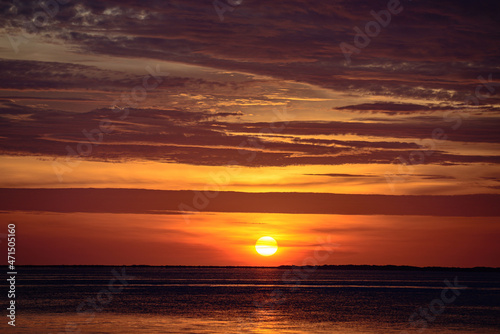 Sunset ocean beach. Bright sunrise with yellow sun under the sea surface. © Volodymyr