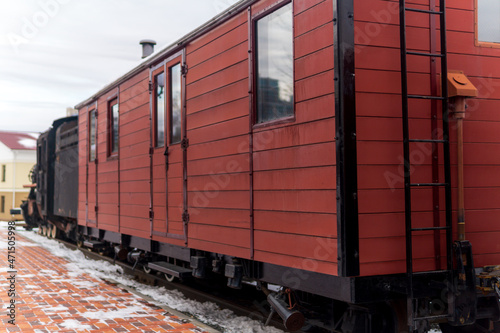 vintage boxcar with a steam locomotive at the station in winter