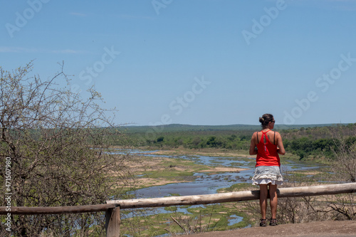 Tourist looking out over the Olifantsrivier in Kruger National Park, South Africa. photo