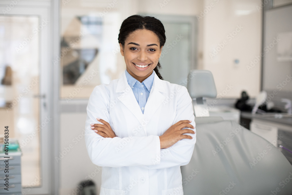 Dental Services. Portrait Of Smiling Black Dentist Woman Posing In Stomatologic Clinic Dental Services. Portrait Of Smiling Black Dentist Woman Posing In Stomatologic Clinic