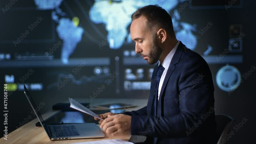 Confident businessman working paper document report and laptop hi tech office global scheme diagram Confident businessman working paper document report and laptop hi tech office global scheme diagram