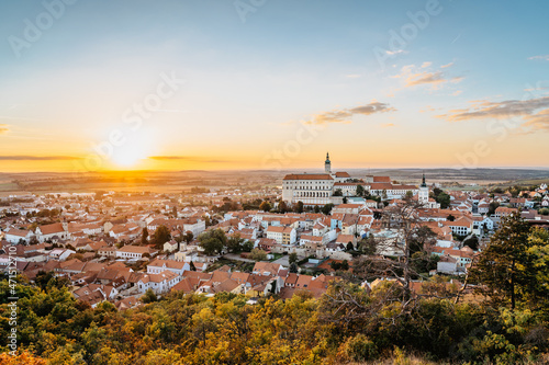 View of Mikulov with beautiful Baroque castle on the rock at sunset,south Moravia,Czech Republic.Dominant of town skyline.Czech Chateau in Palava wine region.Picturesque town among vineyards.