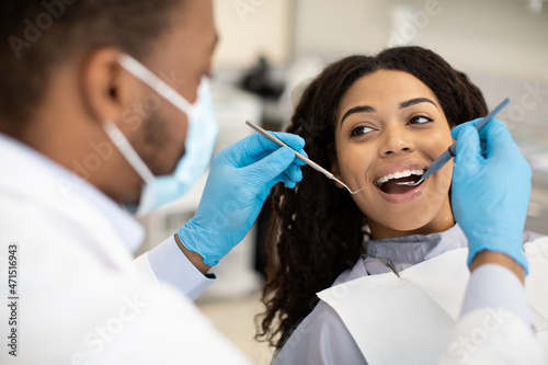 Young African American Woman Having Check Up With Dentist In Modern Clinic