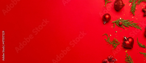 Christmas composition with decorations and ornametns on red background
