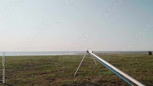 Drone starting its flight in the sky. Amazing sunset in the middle of Tundra in Russia photo