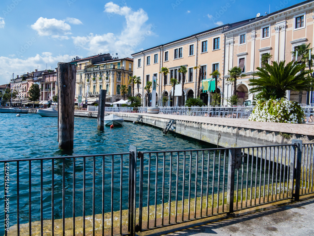 Long table for a dinner event at the edge of the Lake in Salò-Garda lake-Italy