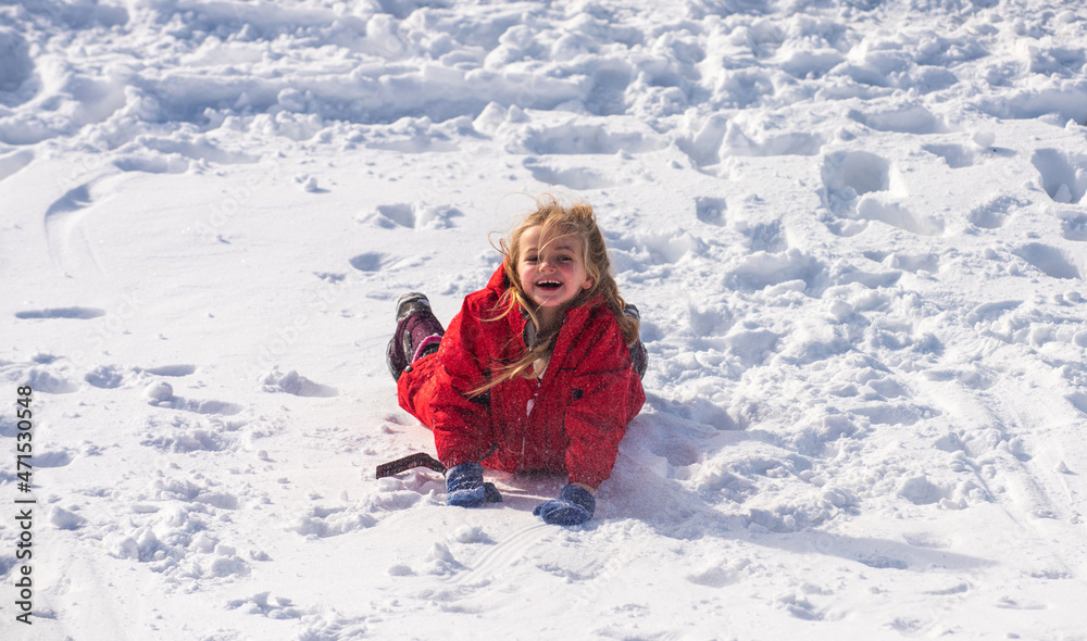 Funny little girl walking outdoors on winter day. Excited christmas holiday. Cute girl laying in snow. Funny little girl walking outdoors on winter day. Excited christmas holiday. Cute girl laying in snow.