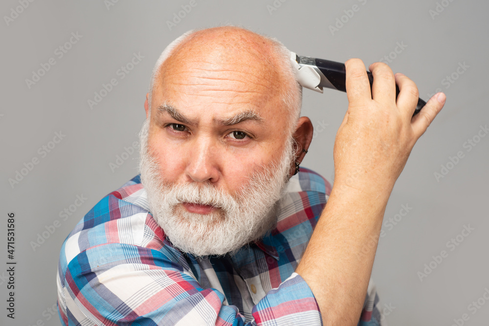 Fototapeta premium Gray man hair clippings. Bald man hairclipper, Mature baldness and hair loss concept.