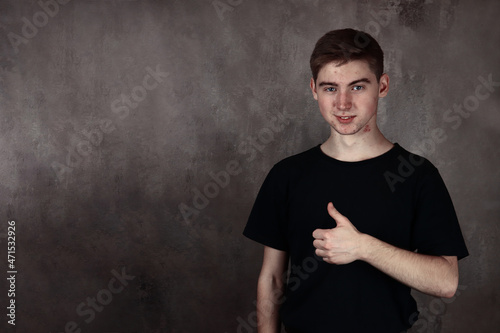 cheerful young man gesturing like. Copy place for text