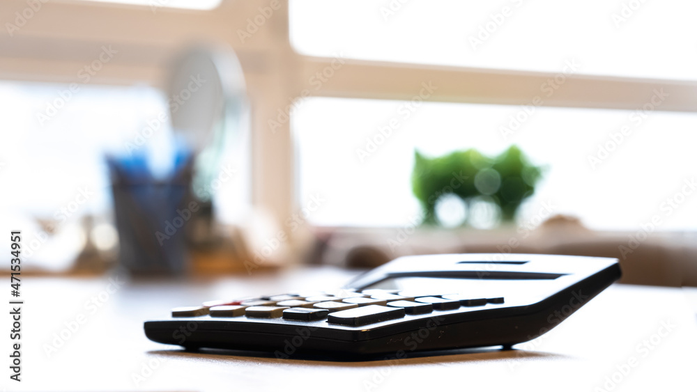 calculator on desk in office calculator on desk in office