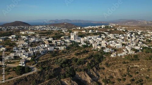 Aerial drone video of beautiful whitewashed village of Tripiti built uphill with great views to Aegean sea and main village or chora of Milos island, Cyclades, Greece photo