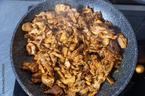 cooking chicken gyros in a pan