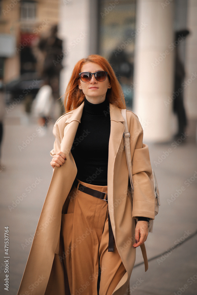 woman walking down the street. walk through the autumn city