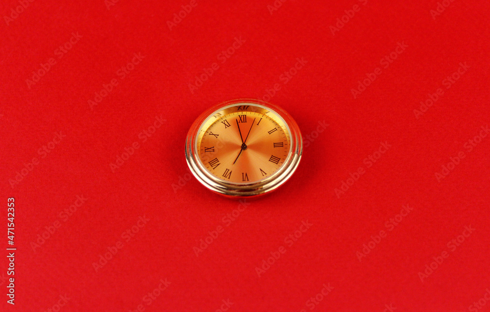 Gold watch on a red background Gold watch on a red background