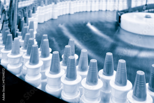 Wallpaper Mural Close-up Many white plastic spray bottles for packaging liquid medicines or cosmetics in a row on a conveyor belt in a pharmaceutical manufacturing factory Torontodigital.ca