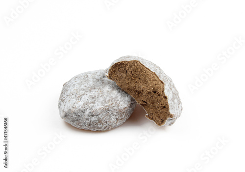 Two belgian truffles covered with powder isolated on white background