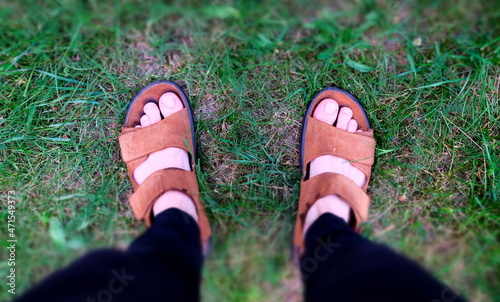 Freedom and nature. Walk barefoot. Feet in green grass