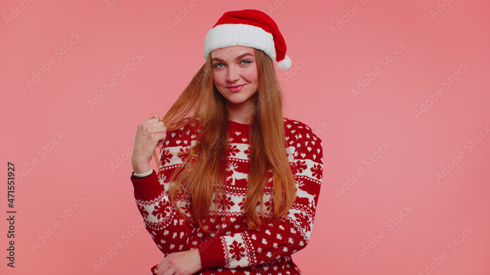 Joyful lovely one girl wears red Christmas sweater, hat smiling looking at camera. Young woman fashion model isolated on pink studio wall background alone. Happy New Year celebration merry holiday Joyful lovely one girl wears red Christmas sweater, hat smiling looking at camera. Young woman fashion model isolated on pink studio wall background alone. Happy New Year celebration merry holiday