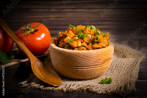 vegetable stew, tomato on wooden background