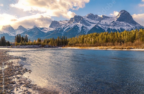 Sunlit Sky Over Canmore Mountains And River