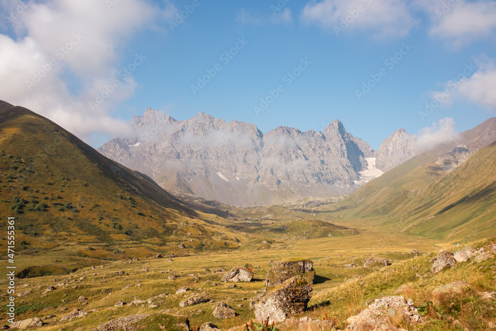 A panoramic view on the sharp mountain peaks of the Chaukhi massif in the Greater Caucasus Mountain Range in Georgia, Kazbegi Region. The valley is full of the Roshka stones. Georgian Dolomites.