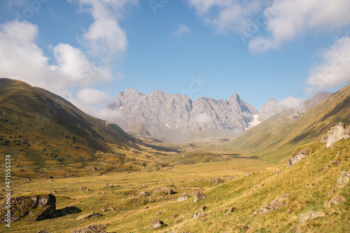 A panoramic view on the sharp mountain peaks of the Chaukhi massif in the Greater Caucasus Mountain Range in Georgia, Kazbegi Region. The valley is full of the Roshka stones. Georgian Dolomites. photo