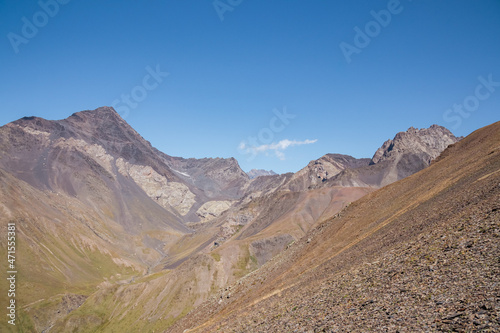 Panoramic view on a mountain chain seen from the Chaukhi Pass in the Greater Caucasus Mountain Range in Georgia, Kazbegi Region. The trail connects the villages of Juta and Roshka. Peak Sosuptano