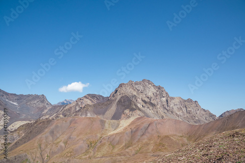 Panoramic view on a mountain chain seen from the Chaukhi Pass in the Greater Caucasus Mountain Range in Georgia, Kazbegi Region. The trail connects the villages of Juta and Roshka. Peak Sosuptano