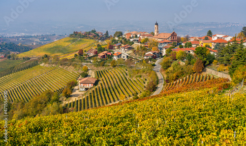 Beautiful hills and vineyards during fall season surrounding Treiso village. In the Langhe region, Cuneo, Piedmont, Italy. photo