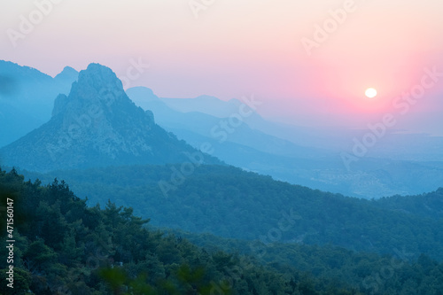 Scenic view of mountains against sky during sunset,through trees .
