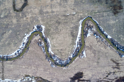 Obraz na płótnie Top view of river running through bare farmland w salonie